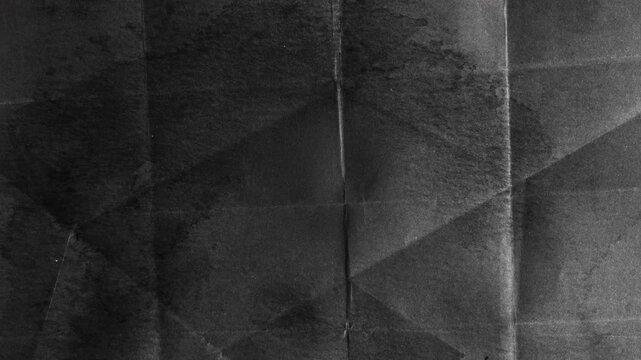 Abstract dark grey geometric paper fold texture background.