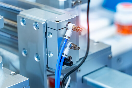 pneumatic hose fittings that connect to air hoses are installed on pneumatic equipment on a production line