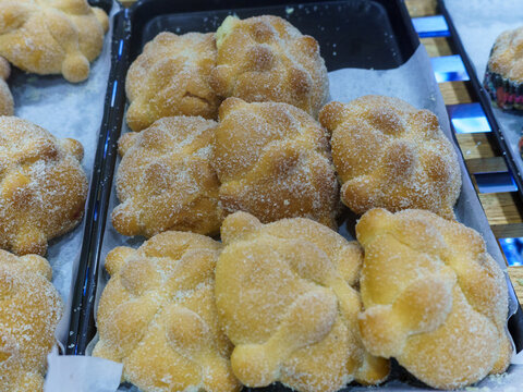 Pan de Muerto Breads Displayed in a Market Bakery Section