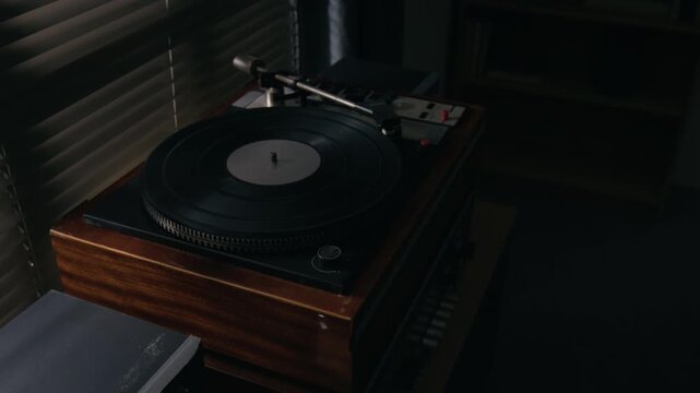 Vintage turntable spinning vinyl record with tonearm playing music. Clip suitable for music production projects, audio equipment advertising, retro lifestyle content, and creative storytelling