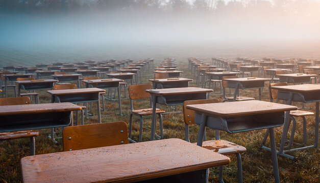 Empty School Desks Arranged in Misty Autumn Field at Dawn