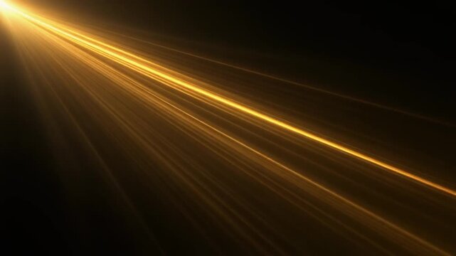 Bright golden light rays shining from the upper left corner on black background