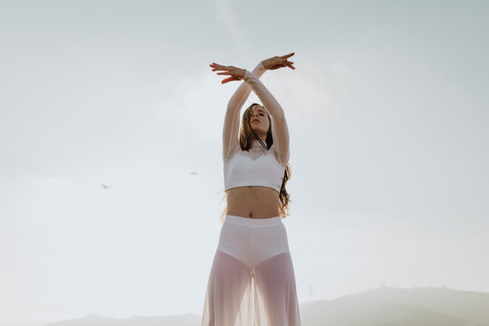 A young woman practices mindfulness and movement outdoors