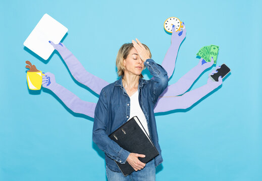 Stressed mature woman juggles multitasking with various paper arms