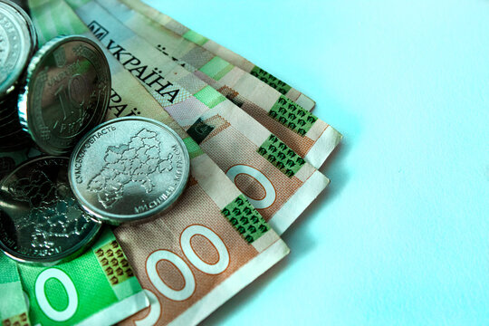 Ukrainian hryvnia coins and banknotes, close-up with space for text
