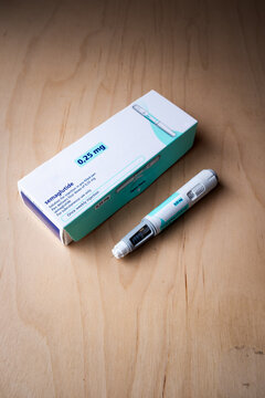 Semaglutide 0.25mg Pre-Filled Injection Pen and Packaging Box on Wooden Desk
