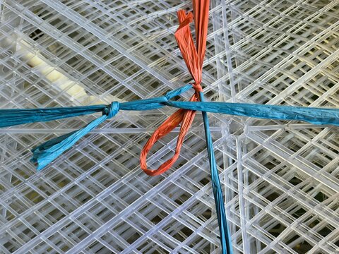 Transparent Plastic Grid Mesh Bound with Blue and Orange Raffia String