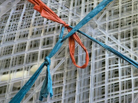 Transparent Plastic Grid Mesh Bound with Blue and Orange Raffia String