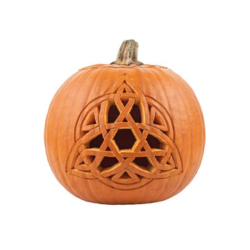 Orange pumpkin carved with an intricate celtic triquetra knot pattern isolated on a transparent background