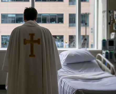 priest  standing in a brightly lit hospital room.