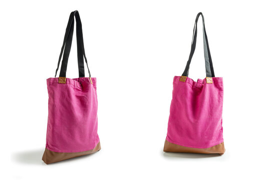 Two pink corduroy tote bags with black straps and brown leather bases shown from different angles on a white background. Template copy space or mockup for lifestyle or shopping