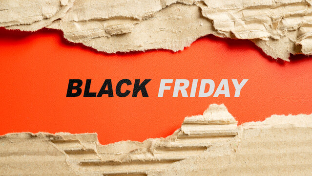 Black Friday text on a red background framed by torn corrugated cardboard. Great for holiday sale promotions. Concept of Black Friday