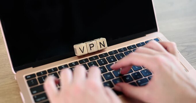 Hands swiftly type on a laptop featuring blocks labeled VPN. This activity highlights the importance of online safety and privacy in today's digital world.