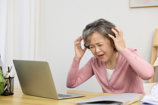 Frustrated Woman on Laptop at Desk