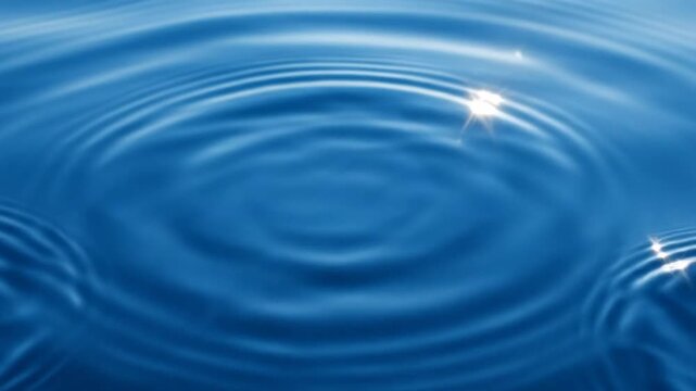 Concentric water ripples on deep blue liquid surface