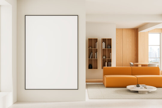 Empty framed poster mockup on a modern living room wall with warm furniture, shelving, and minimalist interior styling for design presentation. 3D Rendering