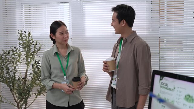 Sustainable ESG Meeting Report with Asian Coworkers Discussing Clean Renewable Wind Energy Strategy, Responsible Business Planning and Sustainable Building Technology in Modern Office Collaboration