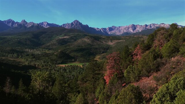 San Juan Mountain RangeUncompahgre National Forest Colorado aerial nature landscape Town of Ridgway Ouray Mount Sneffels Wilderness 14er landmark prominent peak Blue Lakes summer morning blue sky pan