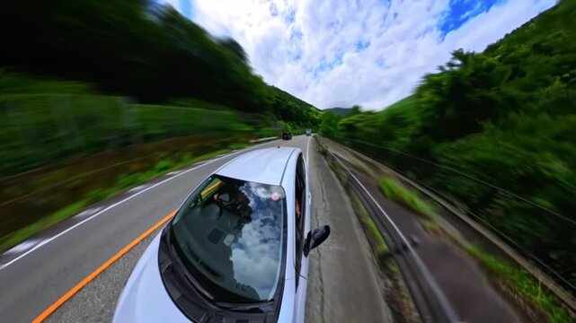 Hyper lapse video, Point-of-view footage from inside a car driving through a lush green mountain road and tunnel, captured with a wide fisheye 360-degree camera. Time-lapse
