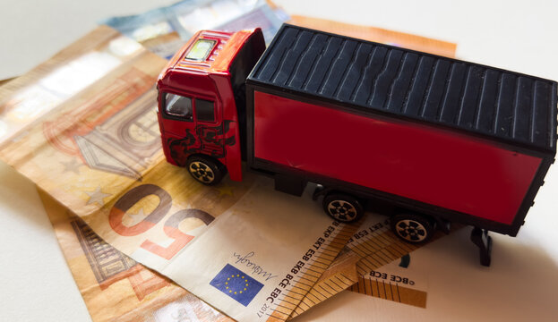 Toy car with money isolated on white background