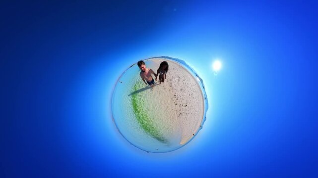 Creative tiny planet effect turns a beach scene into a curved miniature world, showing a person standing on golden sand beside the blue ocean and sky.