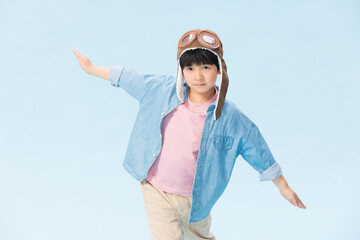 Boy in Aviator Hat and Goggles with Arms Outstretched © CaoBaoTran