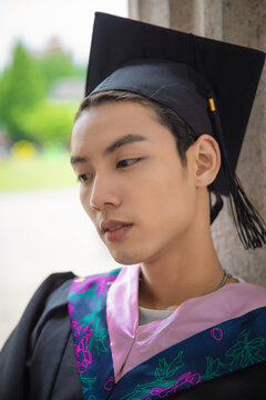 Portrait of Young East Asian Graduate in Academic Regalia