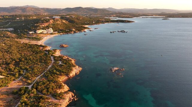 Aerial panoramic view of Costa Smeralda coastline at sunset in Sardinia, Italy