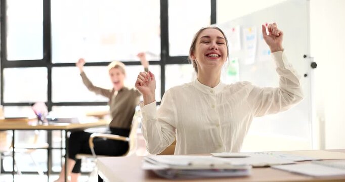 In a sunlit office, two coworkers share delightful moments, celebrating achievements. Laughter and excitement fill the atmosphere as they express their happiness.