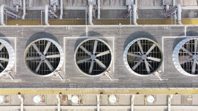 Tracking overhead view of rooftop cooling fans and service pipes