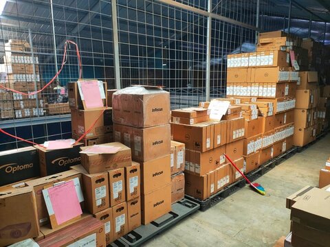 Cimahi, INDONESIA, 20 April 2022 - Warehouse scene with stacked cardboard shipping containers, inventory rows, pallets, and labels. Suitable for logistics, shipping, storage, and inventory concepts.