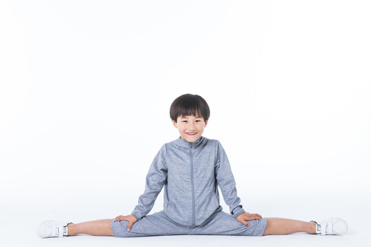 Happy Boy Doing Straddle Stretch