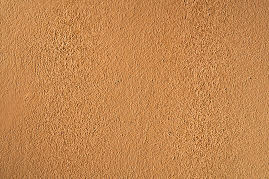 Orange Wall Cement Texture Background With Rough Stucco Surface And Warm Natural Color, Abstract Plaster Pattern For Autumn Fall Design, Architecture, Interior Decoration, Banner And Wallpaper.