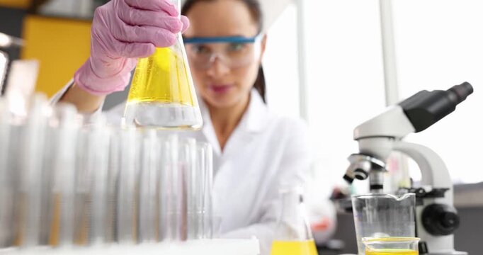 A scientist in protective gear carefully mixes chemicals in beakers and test tubes in a sunlit laboratory. The vibrant colors and precise movements create an atmosphere of discovery and innovation.