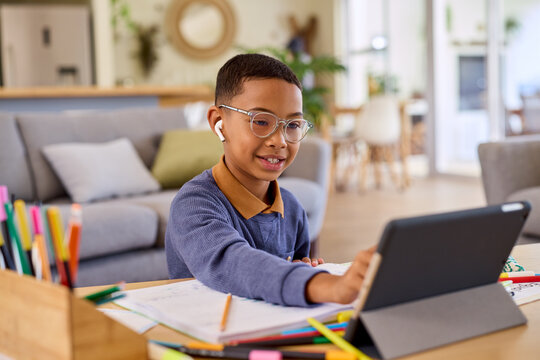 Little black boy studying on digital tablet