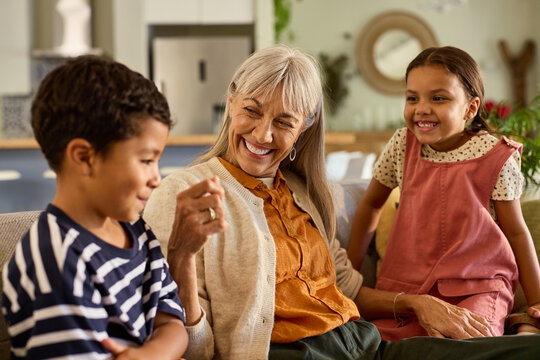 Grandmother playing with her grandchildren at home