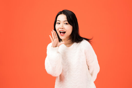 Excited young woman waving hello