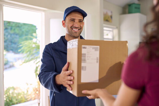 Smiling and friendly delivery man delivering parcel
