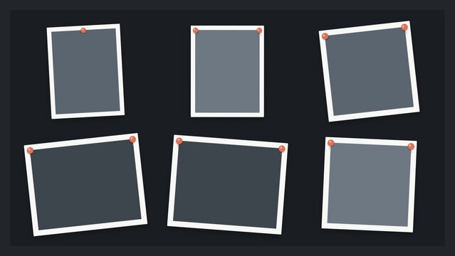 Blank photo frames pinned on dark background