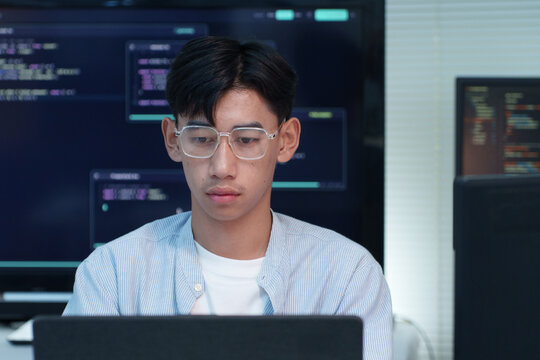 Focused Programmer Coding on Laptop