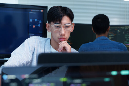 Thoughtful Programmer Developing Digital and AI Technology
