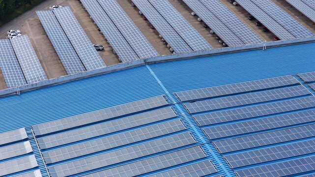 Oblique aerial view of rooftop solar panels and solar carports