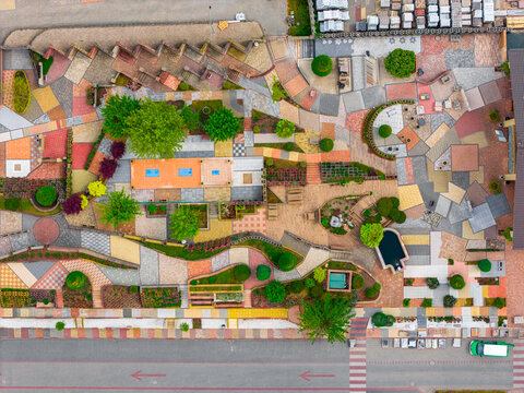 Aerial view of a colorful display area featuring various paving stones, tiles, and landscaping materials arranged in geometric patterns with small trees in Otnice, South Moravian Region, Czechia.