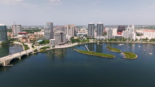 Aerial: pull out drone shot of cityscape with Royal Park Bridge, One Flagler and Phillips Point building in West Palm Beach, Florida, USA