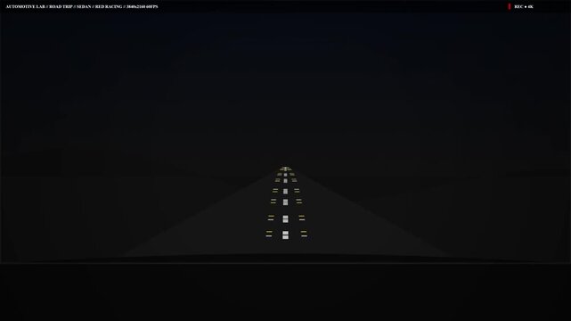 Night driving view on dark highway road illuminated by car headlights showing center line and yellow markers