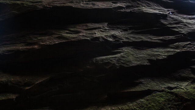 Dark rock cliff ledge overhang texture close up background