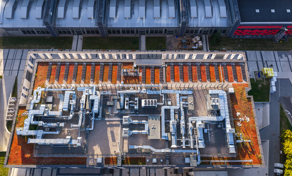 Aerial view of a data centre roof featuring complex HVAC ventilation systems and green roof sections in an industrial area in Gdansk, Pomeranian Voivodeship, Poland.