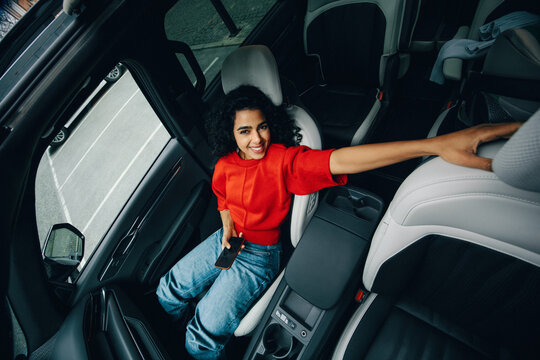 Her smartphone keeps the woman occupied as a passenger in the car