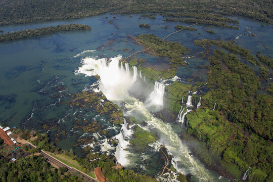 Aerial view of the powerful Iguazu Falls surrounded by dense tropical rainforest and the Iguazu River in Misiones Province, Argentina.