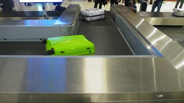 Close up of luggage being moved around an airport, colorful suitcases, 4k